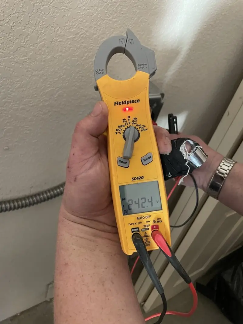 Voltage testing with clamp meter during Recessed Lighting Installation in Joshua